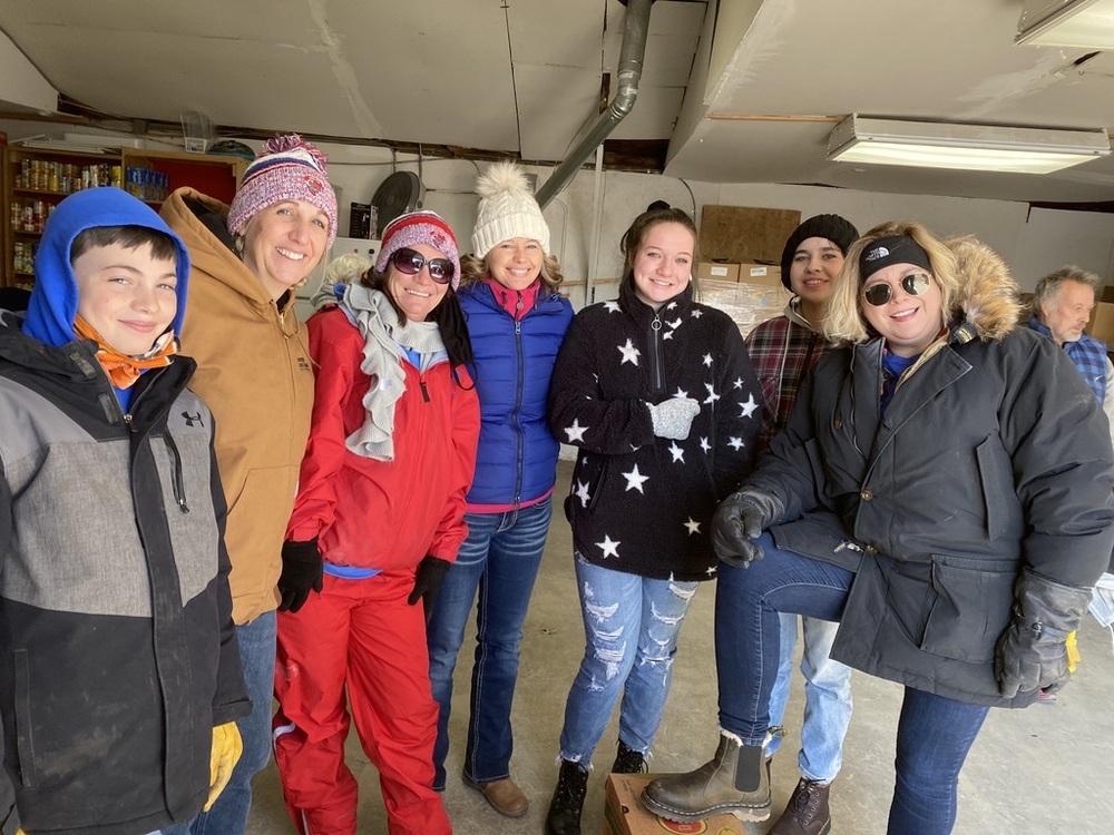 Members of USD #436 and their families pictured as they assist at the food pantry.